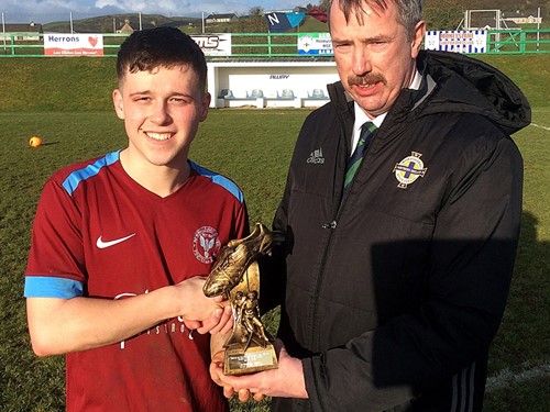 Alistair Gray of the Irish FA Intermediate Cup Committee presents Man of the Match Dylan McCorkell of Newbuildings United with his trophy.jpg